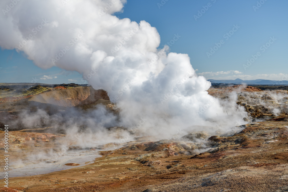 Hot steam rising to the sky in Gunnuhver geothermal area in Iceland