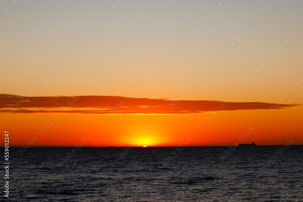 The sun sets over the beach in Melbourne on a summer evening The sun sets over the beach in Melbourne on a summer evening