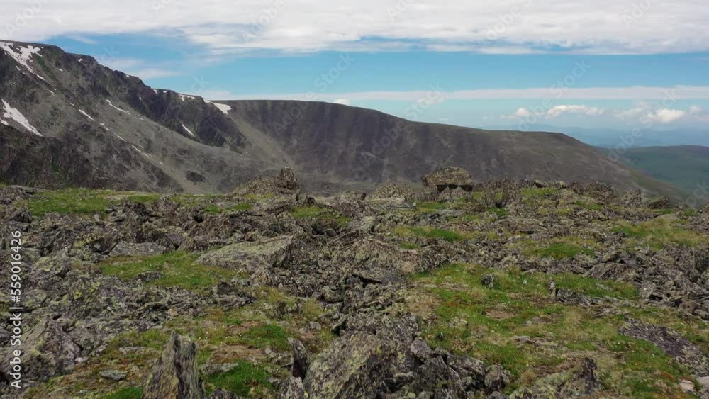 Aerial video of mount Sarlyk top and slopes. The drone flies at low altitude over rock streams to the the cirque with glacial lakes. Aerial video of mount Sarlyk top and slopes. The drone flies at low altitude over rock streams to the the cirque with glacial lakes.