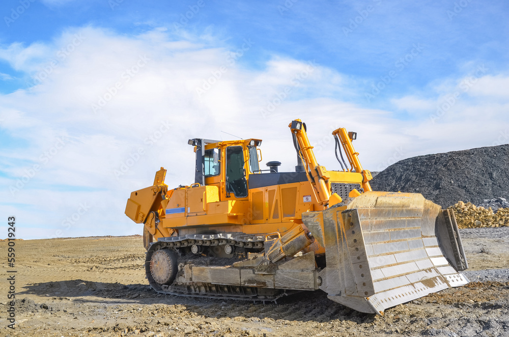 Big crawler dozer working on construction site or quarry. Mining machinery moving clay, smoothing gravel surface for new road. Earthmoving, excavations, digging on soils Big crawler dozer working on construction site or quarry. Mining machinery moving clay, smoothing gravel surface for new road. Earthmoving, excavations, digging on soils