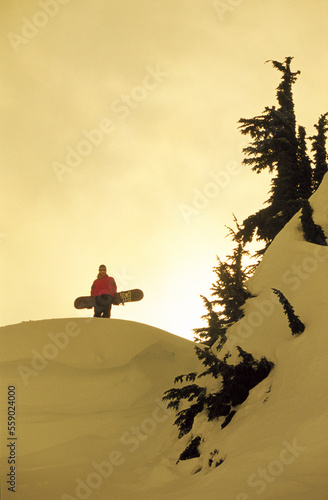 Female snowboarder silohette in backcountry. photo