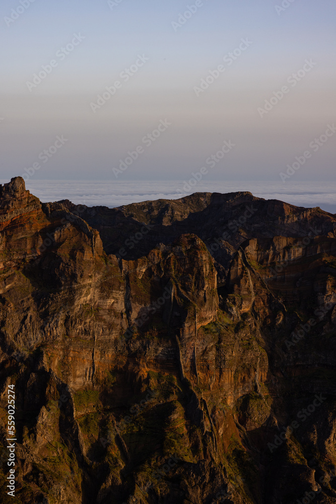 Amazing sunset on Pico Ruivo with a view of Pico do Arieiro during the golden hour, perfect for photography.