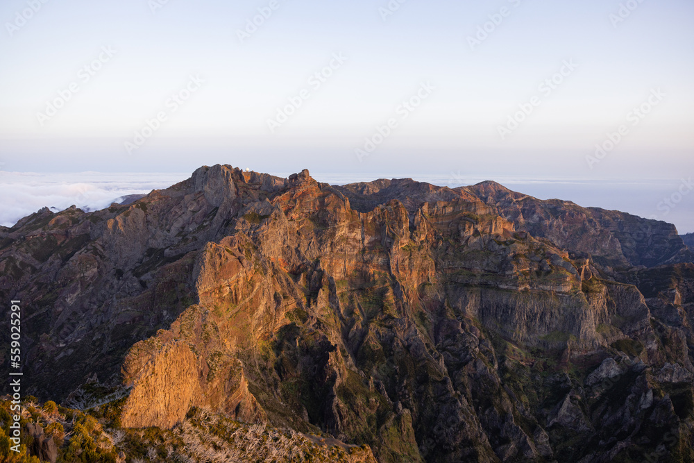 Great views of an epic colorful sunset over the mountain peaks of Madeira.
