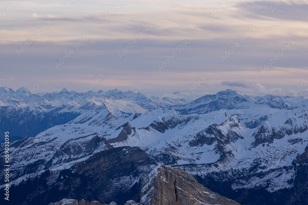 Shot from behind the peaks of the Swiss mountains during the golden hour, perfect for photography.
