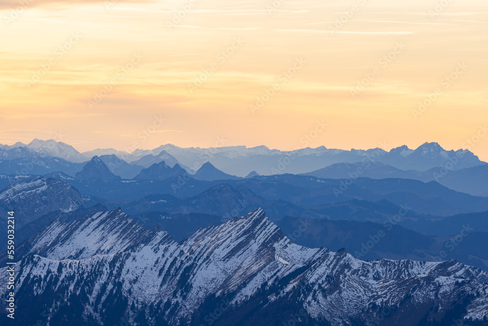 Beautiful colored horizon with red, orange and pink tones behind the mountains of Switzerland.