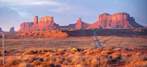 Monument Valley at sunset, panoramic photo with long road to the right © Larry Zhou