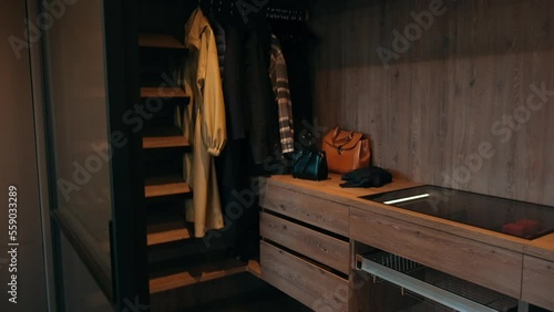 camera zoom in a small dark closet. panorama over a small dark wardrobe