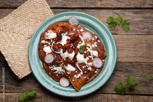 Mexican enfrijoladas with chorizo and fresh cheese