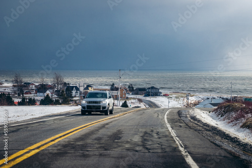 Car driving on a road on the coastline of Canada © Elric CHAPELON
