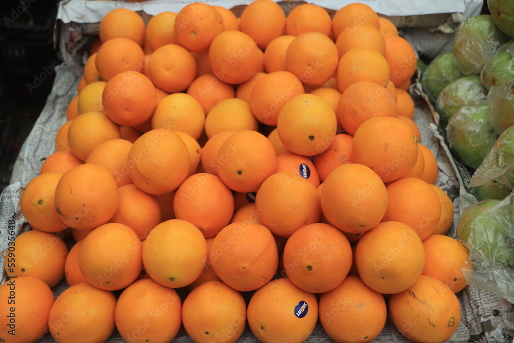 Fresh juicy orange display on market