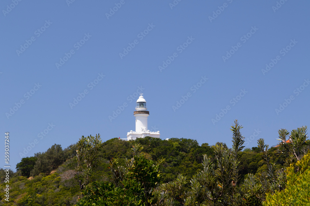 A white lighthouse on a hill