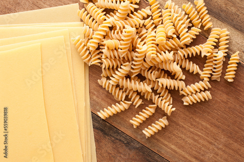 Assorted raw Italian pasta on a wooden table © Stephen Gibson