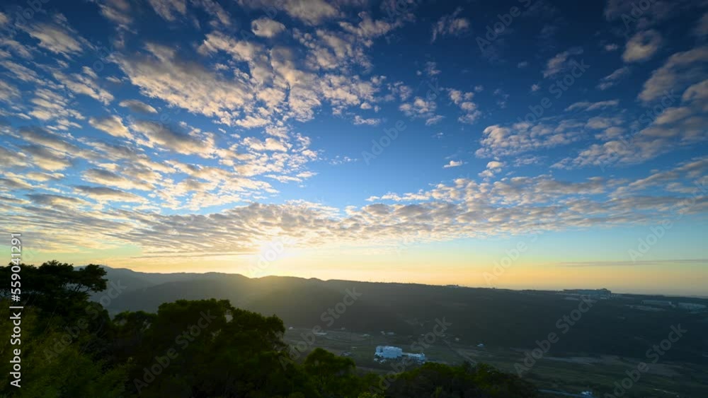 Romantic and spectacular cityscape at sunset. Moving clouds in blue sky. The hazy and dreamy twilight view of the city. Miaoli County, Taiwan Romantic and spectacular cityscape at sunset. Moving clouds in blue sky. The hazy and dreamy twilight view of the city. Miaoli County, Taiwan