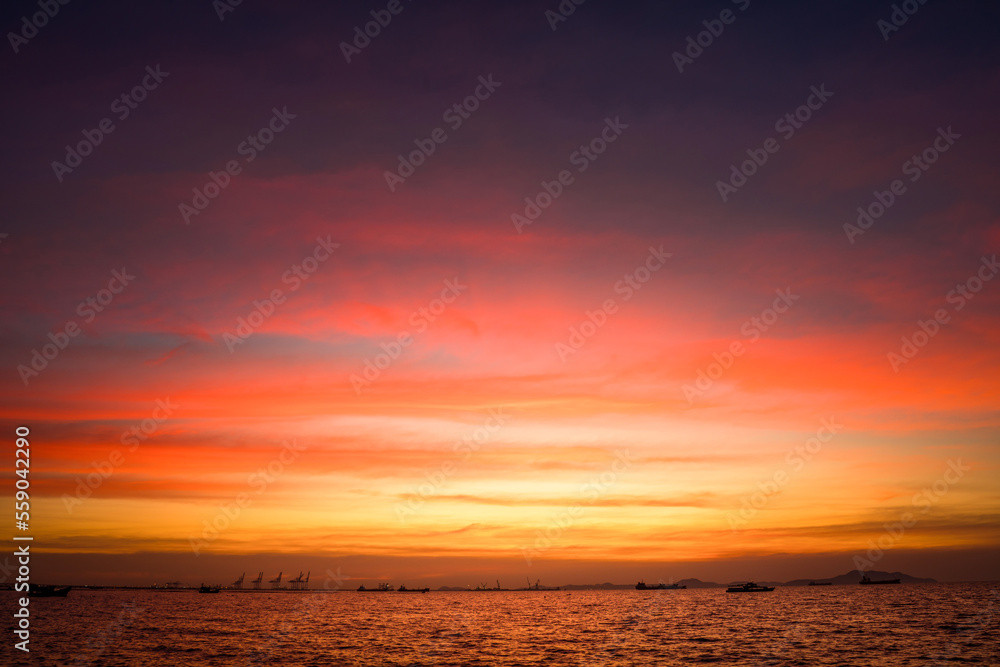 Obraz premium Sunset Colorful sunset at the sea. Romantic Sunet go down, blue and orange clouds flow in sky. Majestic summer landscape. Beautiful sky fluffy clouds evening day