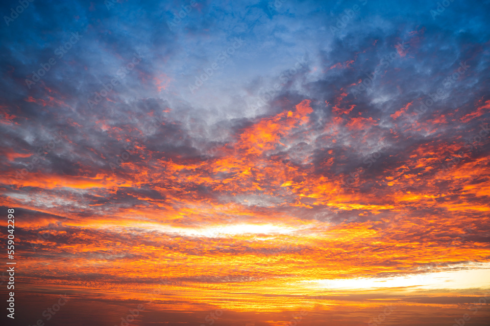 Fototapeta premium Sunset Colorful sunset at the sea. Romantic Sunet go down, blue and orange clouds flow in sky. Majestic summer landscape. Beautiful sky fluffy clouds evening day