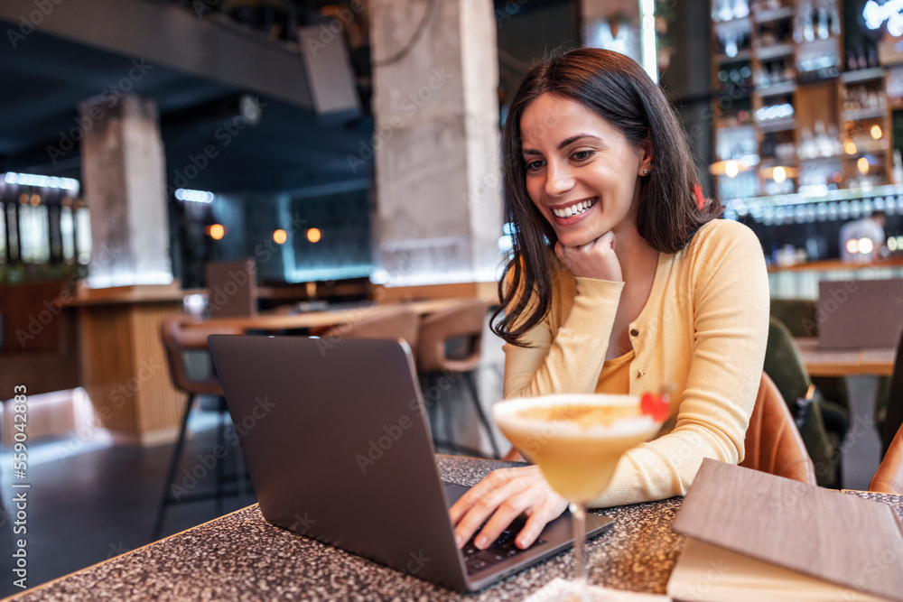 Woman using notebook in cafe