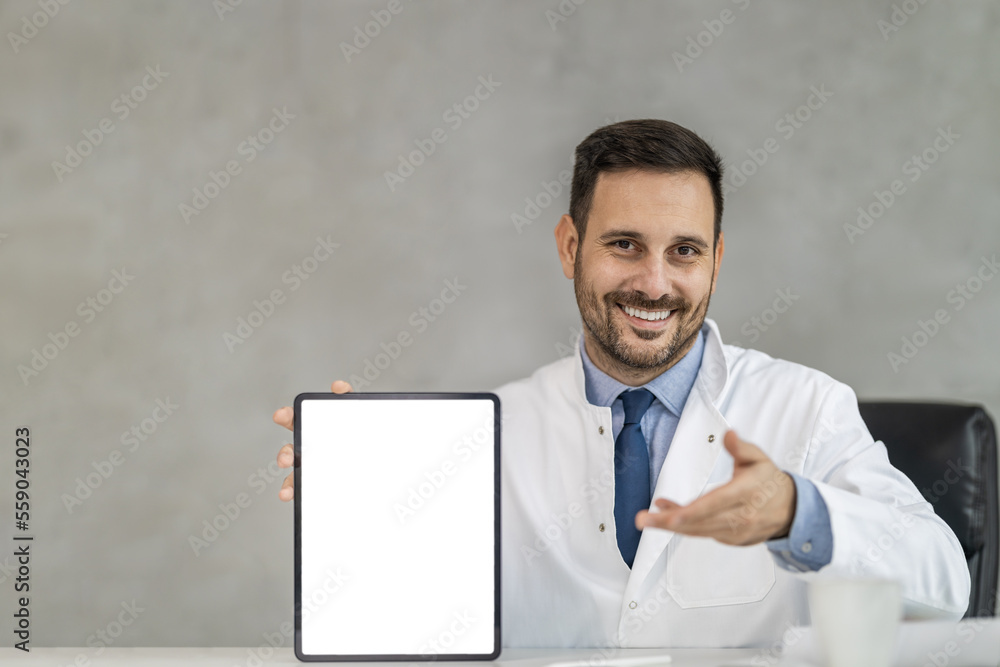 Portrait of male doctor holding digital tablet and looking at camera Portrait of male doctor holding digital tablet and looking at camera