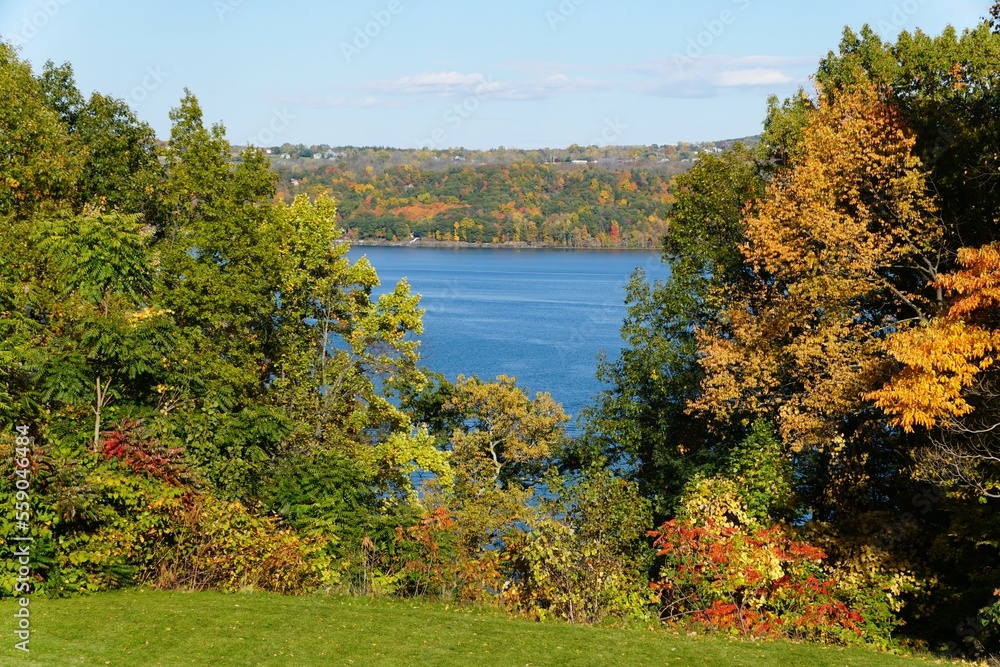 A distance water view with the background of fall foliage near Cayuga Lake, New York
