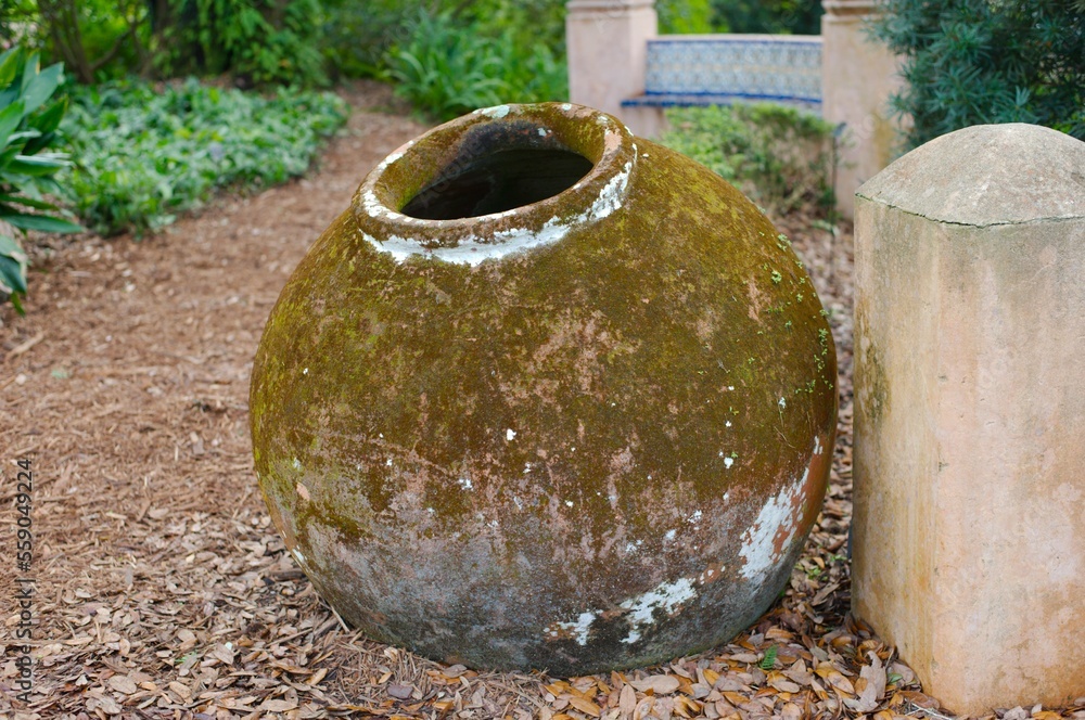 water container Old round water pot brown outdoors on ground cistern on brown path beside building. Old clay jar with a circular opening. water container Old round water pot brown outdoors on ground cistern on brown path beside building. Old clay jar with a circular opening.