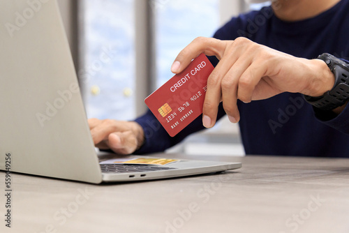 Businessman holding credit card for online shopping bill on smartphone, positive man shopping online remote payment , smart payment concept individual bank