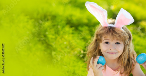 Easter bunny child boy with cute face. Kids hunting easter eggs. Children activity for Easter in nature. Horizontal photo banner for website header design with copy space.