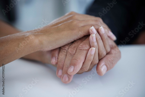 Fototapeta Naklejka Na Ścianę i Meble -  Hands, support and trust with a business woman consoling or comforting a man employee in the office at work. Help, love and hope with a female and male employee holding hands in comfort or support