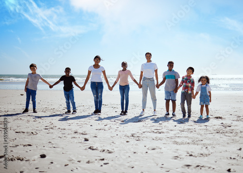 Beach, holding hands and lesbian women with children for support, holiday diversity and big family love in Indonesia. Trust, hope and portrait of parents with kids for a travel vacation at the sea