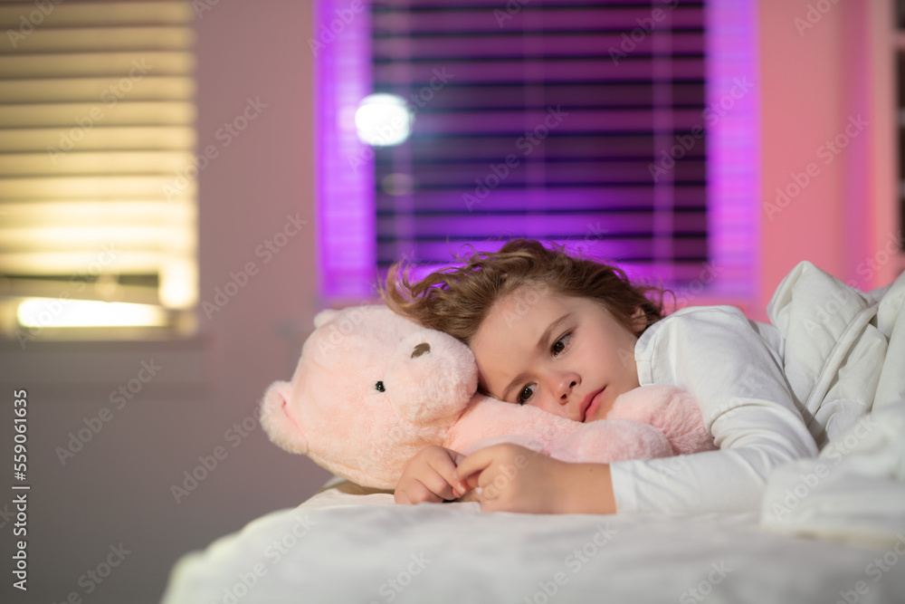 Child cannot sleep on bed at night in bedroom. Kid having sleeplessness