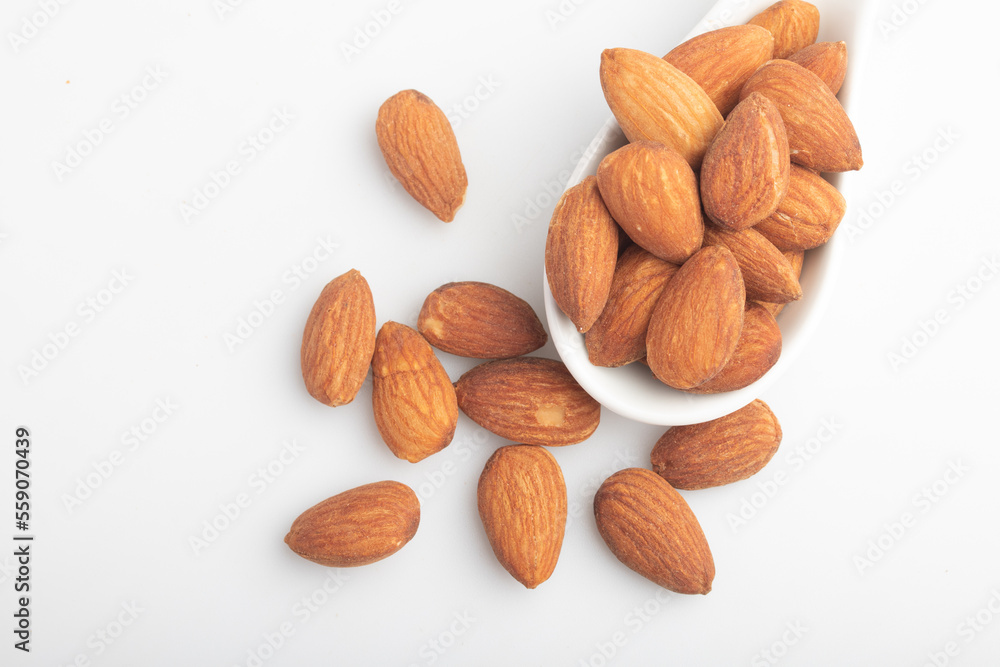 Salted almonds in a white cup.Copy space. Salted almonds in a white cup.Copy space.