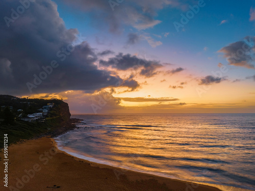 Rainy day sunrise seascape with clouds