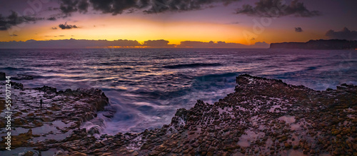 Dawn panorama over the ocean and rock platform