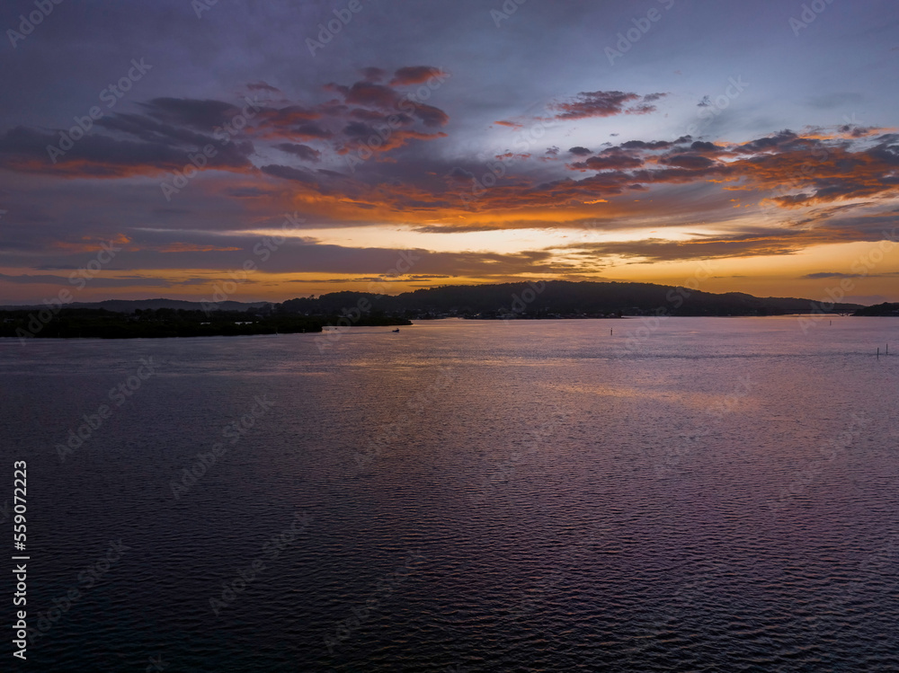 Fototapeta premium After the rain sunrise waterscape with clouds