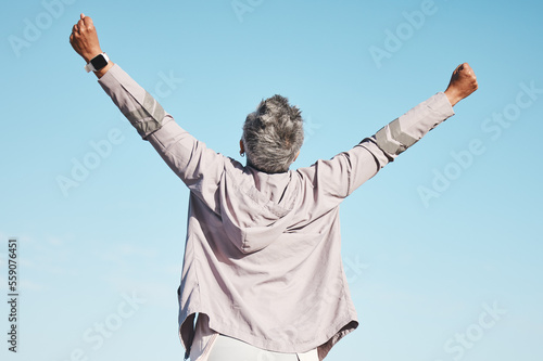 Freedom, fitness and woman hands in air on blue sky mockup for exercise, fitness or workout training goals, success and achievement. Winner, wow and healthy senior or runner rear in nature wellness