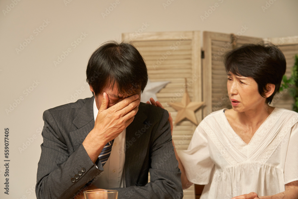 家で落ち込む中年のサラリーマン