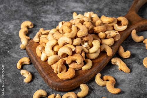 Cashew on wood serving board. A pile of cashews. Studio shoot. close up