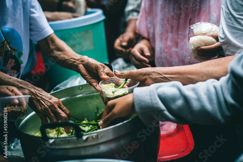 The concept of humanitarian assistance: sharing food to the poor.
