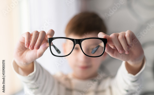 Banner little boy with glasses correcting myopia close-up portrait Ophthalmology problem selective focus