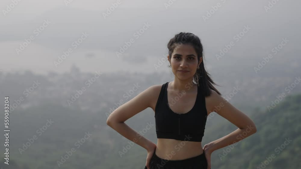close-up sport Indian young woman with long dark hair exercising in an outdoor mountain during daytime, deep breathing, in looking at camera. beautiful Asian girl exercises on enjoy in the morning. close-up sport Indian young woman with long dark hair exercising in an outdoor mountain during daytime, deep breathing, in looking at camera. beautiful Asian girl exercises on enjoy in the morning.
