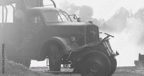 German World War Ii Automotive. German Military Ammunition. German Vehicle Truck Opel Blitz And German Infantry Cart Or Handcart Infanteriekarren If8 Of World War Ww Ii. Black And White Video. photo