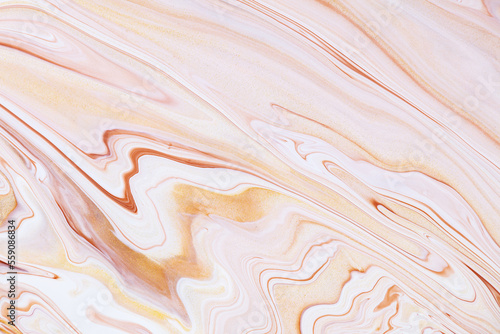 Fluid art texture. Background with abstract mixing paint effect. Liquid acrylic picture with colorful mixed paints. Can be used for background or poster. Golden, brown and beige overflowing colors.