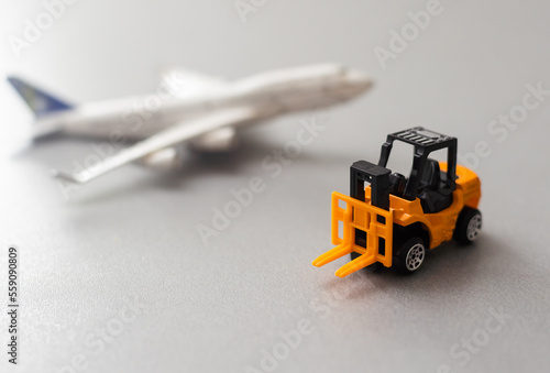 miniature toy excavator and plane. Industry concept.