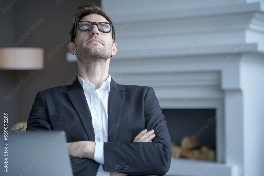 Mediative german businessman sit at desk with eyes closed taking rest from computer work Mediative german businessman sit at desk with eyes closed taking rest from computer work