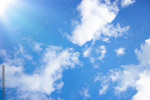 Abstract background. Natural background. The sun s rays. Blue sky with white clouds. Copy space