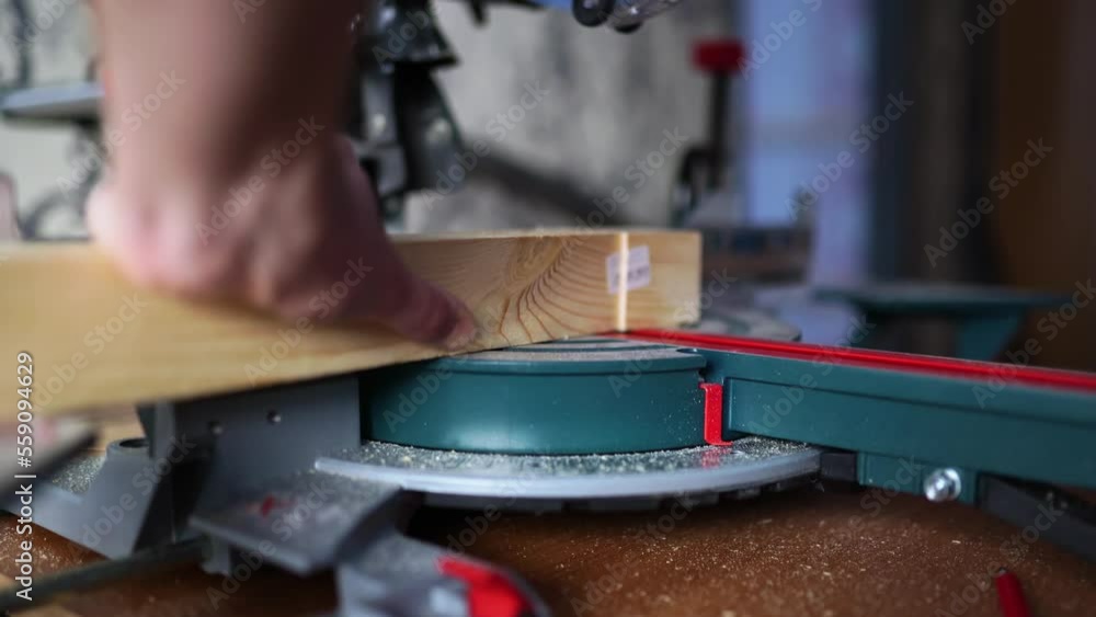 cutting wood with a miter saw. construction tool at work cutting wood with a miter saw. construction tool at work