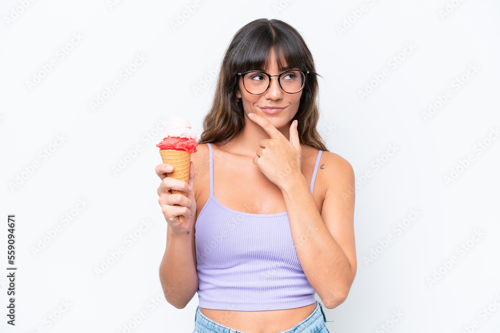 Young caucasian woman with a cornet ice cream over isolated white background thinking Young caucasian woman with a cornet ice cream over isolated white background thinking