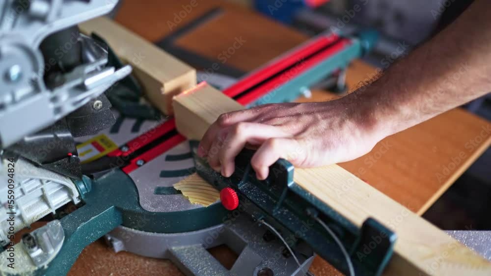 cutting wood with a miter saw. construction tool at work cutting wood with a miter saw. construction tool at work