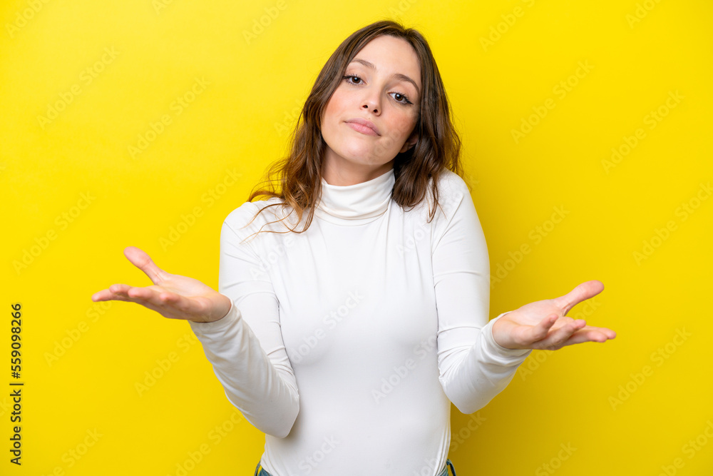 Young caucasian woman isolated on yellow background having doubts Young caucasian woman isolated on yellow background having doubts