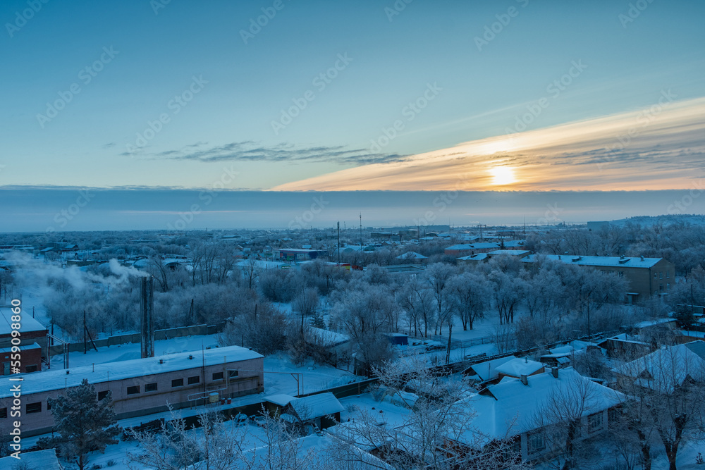 Scenic top view of snow-covered houses on a winter morning.