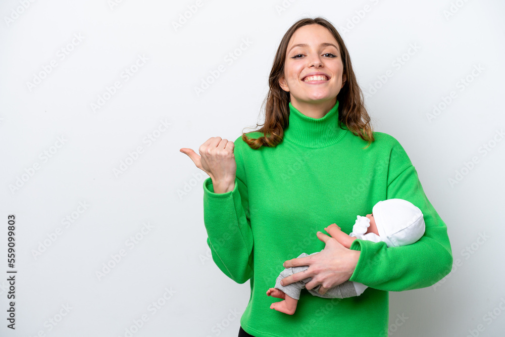 Young caucasian woman with her cute baby isolated on white background pointing to the side to present a product Young caucasian woman with her cute baby isolated on white background pointing to the side to present a product