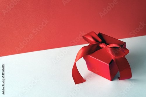 red gift box with satin ribbon isolated on white background, copy space